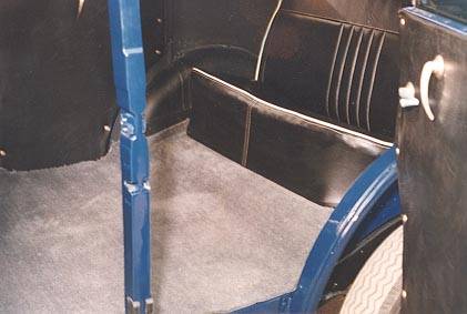 Interior view showing door handles, rear seat